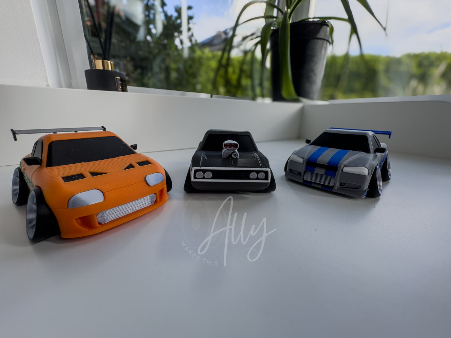 Front view with silver grill and stylised design shown with other JDM and muscle cartoon cars
