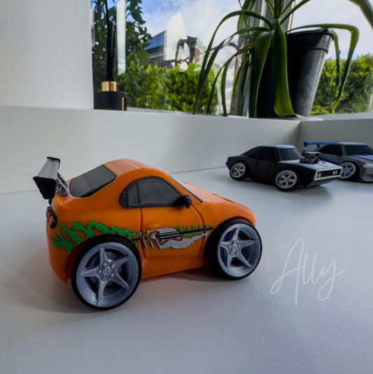 Orange cartoon-style JDM car with green and silver side graphics